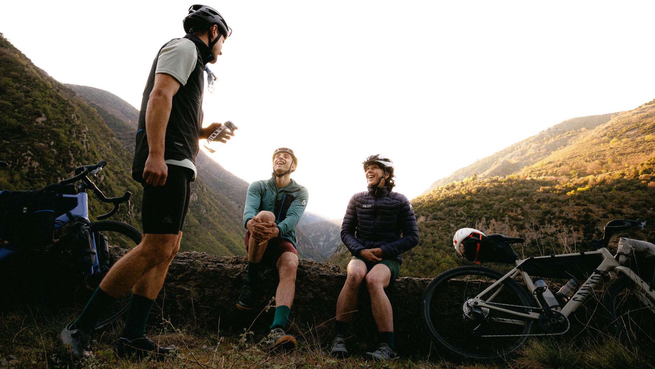 Nutrition advice when doing long-distance cycling&mdash;cyclists take a break to refuel and hydrate during a mountainous tour.